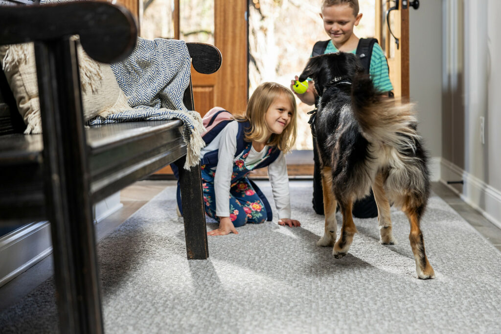 Kids playing with dog | Gil's Carpets